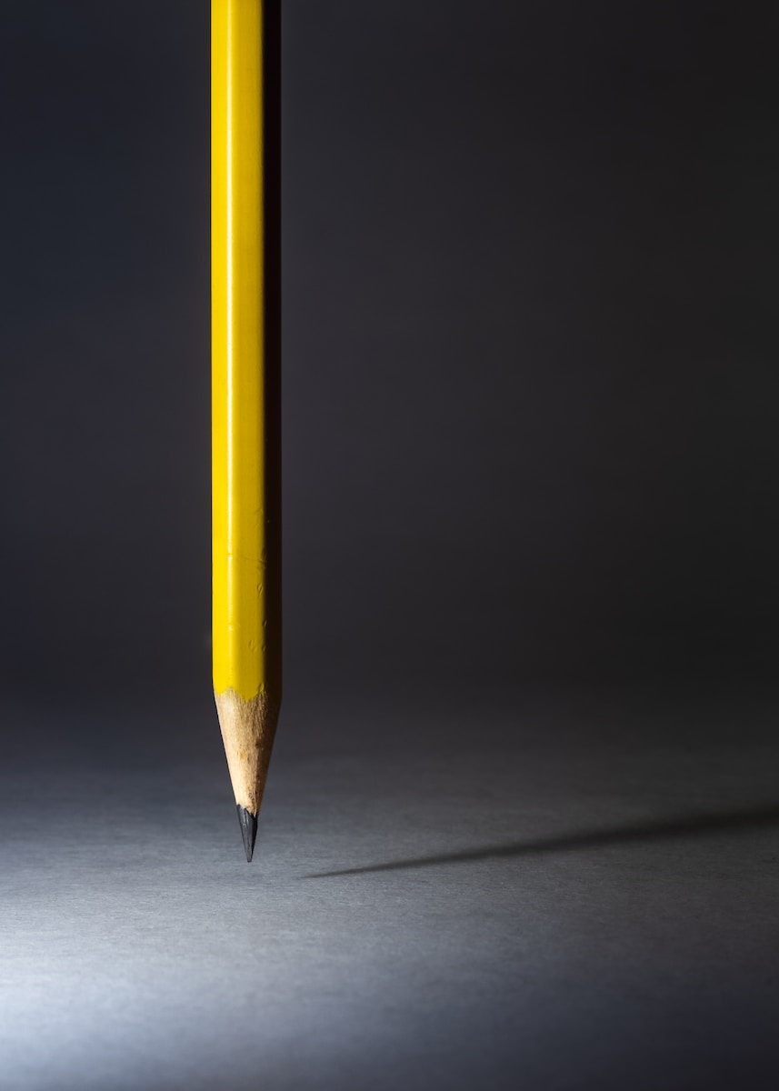a yellow pencil with a black background